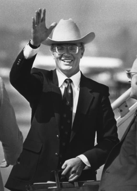 Former Secretary of the Interior, James Watt, wearing a cowboy hat, smiles and waves at the Santa Barbara Airport on boarding an airliner on October 16, 1983, to leave after a week and a half stay at a private ranch near here. During his stay, on October 9, Watt resigned as secretary of the interior. File Photo by Mike Hill/UPI