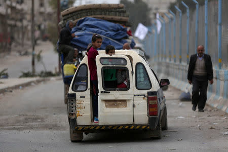 Children ride in a vehicle in the center of Afrin, Syria March 24, 2018. REUTERS/Khalil Ashawi