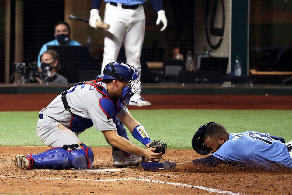 Manuel Margot #13 of the Tampa Bay Rays is tagged out by Austin Barnes #15 of the Los Angeles Dodgers on an attempt to steal home during the fourth inning in Game Five of the 2020 MLB World Series at Globe Life Field on October 25, 2020 in Arlington, Texas. (Photo by Rob Carr/Getty Images)