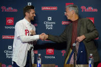 Newly acquired Philadelphia Phillies shortstop Trea Turner, left, shakes hands with Phillies president of baseball operations David Dombrowski during an introductory news conference, Thursday, Dec. 8, 2022, in Philadelphia. (AP Photo/Matt Slocum)