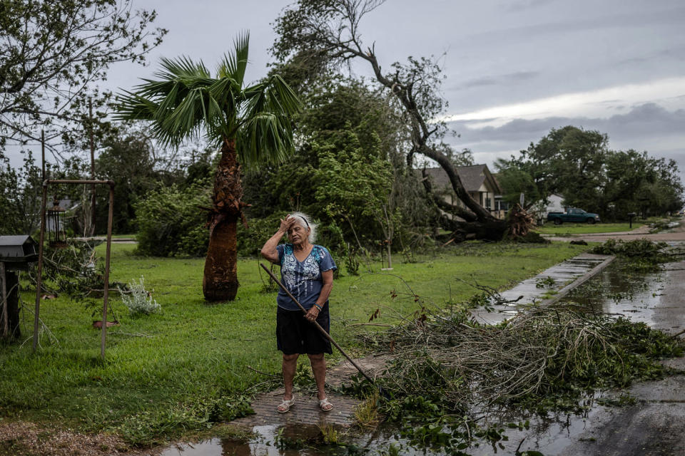 Woman grieves tree uprooted by Hurricane Beryl in Freeport, Texas (Adrees Latif / Reuters)