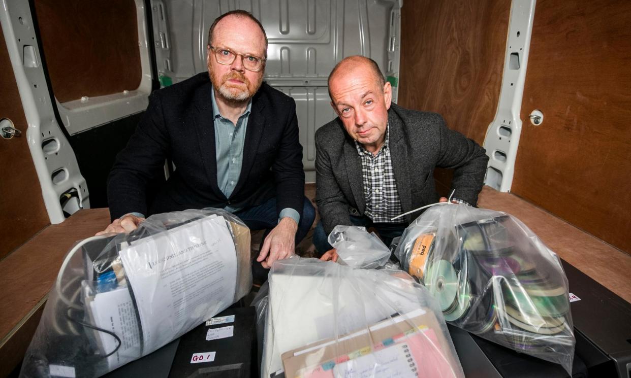 <span>Trevor Birney (left) and Barry McCaffrey outside Castlereagh police station in Belfast, with a haul of journalistic material unlawfully seized by police in June 2019. </span><span>Photograph: Liam McBurney/PA</span>