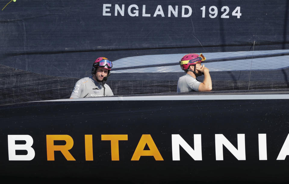 Ben Ainslie, left, skipper on Britain's INEOS Team UK races Italy's Luna Rossa to win race six of the Prada Cup on Auckland's Waitemata Harbour, New Zealand, Saturday, Feb.20, 2021. (Dean Purcell/NZ Herald via AP)