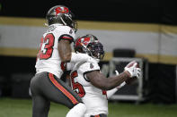 Tampa Bay Buccaneers inside linebacker Devin White, right, celebrates after his interception with cornerback Sean Murphy-Bunting (23) against the New Orleans Saints during the second half of an NFL divisional round playoff football game, Sunday, Jan. 17, 2021, in New Orleans. (AP Photo/Butch Dill)