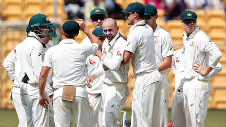 Australia's Nathan Lyon celebrates the wicket of India's Ravichandran Ashwin with his team mates. REUTERS/Danish Siddiqui