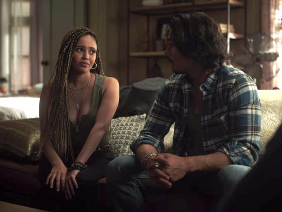 Vanessa Morgan and Drew Ray Tanner sitting on a couch on season five of "Riverdale."