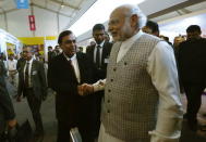 Prime Minister Narendra Modi (L) shakes hand with Mukesh Ambani, chairman of Reliance Industries Limited during a visit to a pavilion at the exhibition centre of the 'Make In India' week in Mumbai, February 13, 2016. REUTERS/Danish Siddiqui