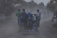 A passenger jeepney drives through a road covered in volcanic ash from Taal volcano's eruption on January 13, 2020 in Lemery, Batangas province, Philippines. (Photo by Ezra Acayan/Getty Images)