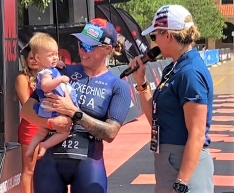 Kelly Ann McKechnie (422) holds her daughter Bryan during an interview after completing the IRONMAN 70.3 Lubbock triathlon Sunday, June 26, 2022.