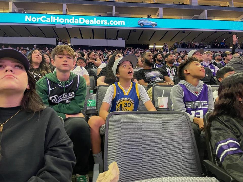 Sacramento Kings fan Ethan Whipple, 13, watches the big screen with friend Joey French, 12, a Golden State Warriors fan, at the Game 3 watch party at Golden 1 Center on Thursday.