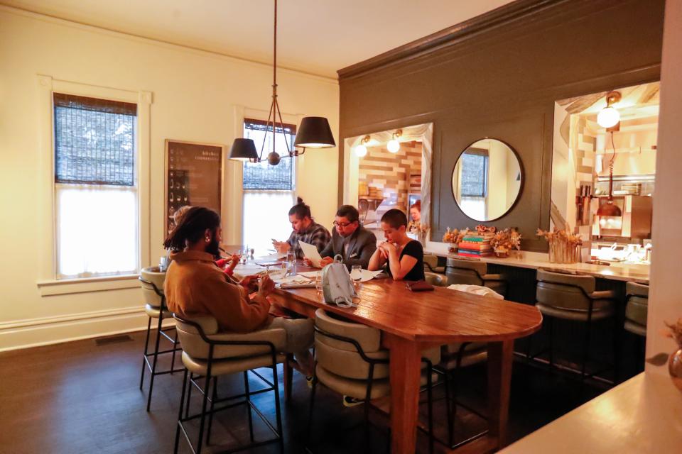 Guests sit in a dining area near the kitchen at Common Thread.