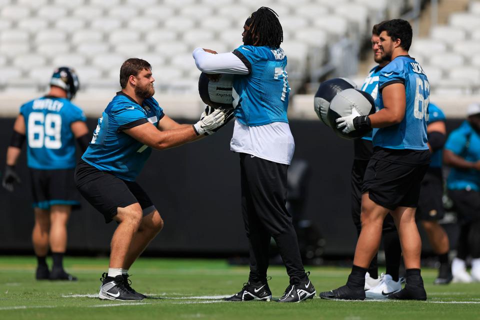 Jaguars guard Cooper Hodges (75), left, works out with offensive tackle Anton Harrison (76) during organized team activities on May 30.