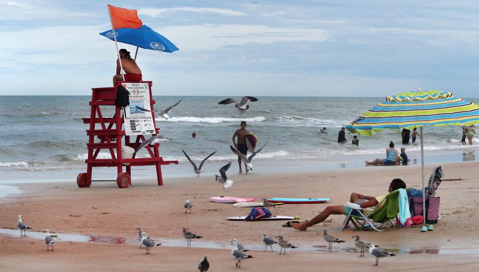 A Volusia County lifeguard keeps watch on the swimmers on Aug. 31, 2023, in front of Andy Romano Beachfront Park in Ormond Beach.