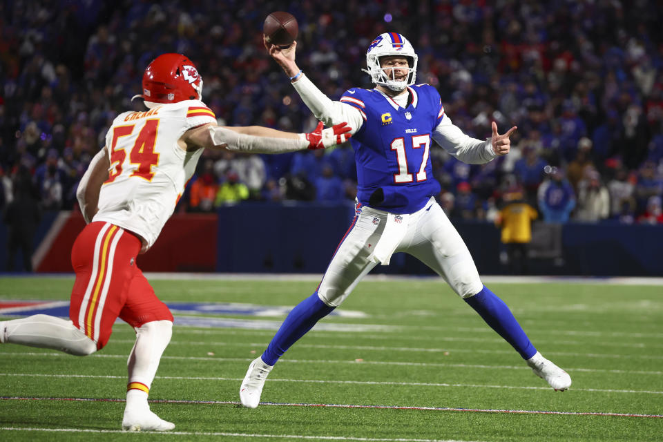 Buffalo Bills quarterback Josh Allen (17) throws a touchdown pass under pressure from Kansas City Chiefs linebacker Leo Chenal (54) during the third quarter of an NFL AFC division playoff football game, Sunday, Jan. 21, 2024, in Orchard Park, N.Y. (AP Photo/Jeffrey T. Barnes)