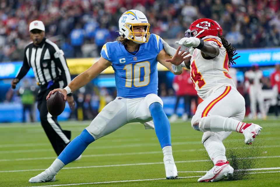 Los Angeles Chargers quarterback Justin Herbert looks to pass under pressure from Kansas City Chiefs outside linebacker Nick Bolton during their game last week in Inglewood, Calif. Herbert should have a quality outing against the Texans for the fantasy semifinals.