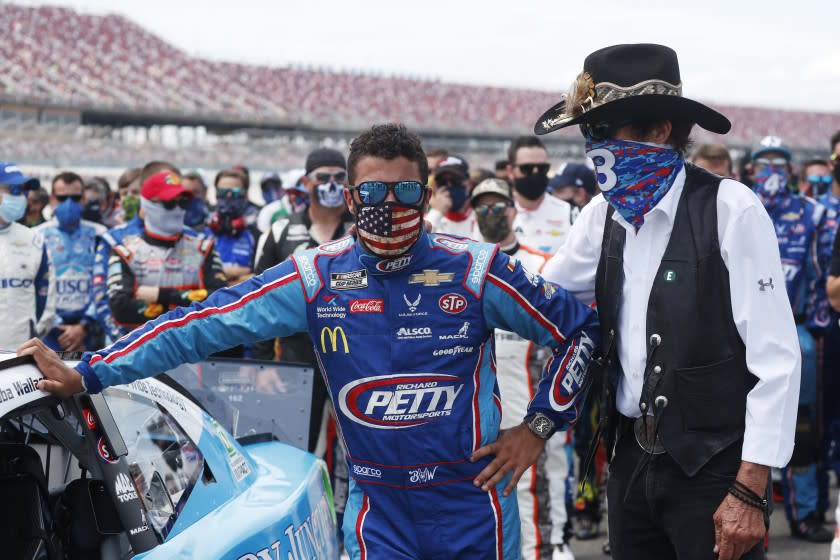 Team owner Richard Petty stands with driver Bubba Wallace.