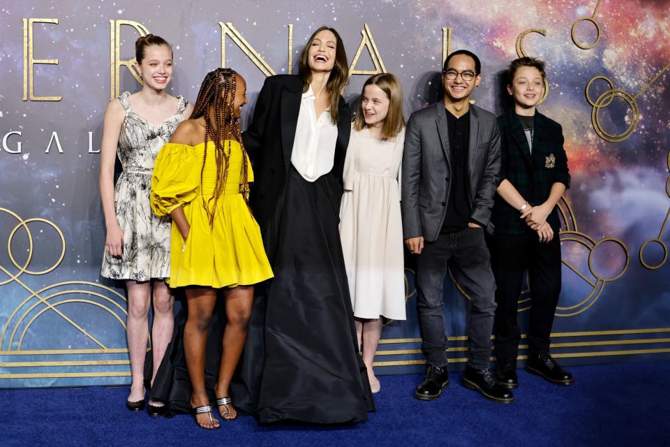 Angie with five of her kids on the Eternals red carpet, all of them smiling