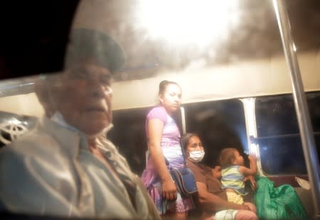 People are seen in a bus before evacuation in San Lorenzo Community, an area where wildfires have destroyed hectares of forest, near Robore