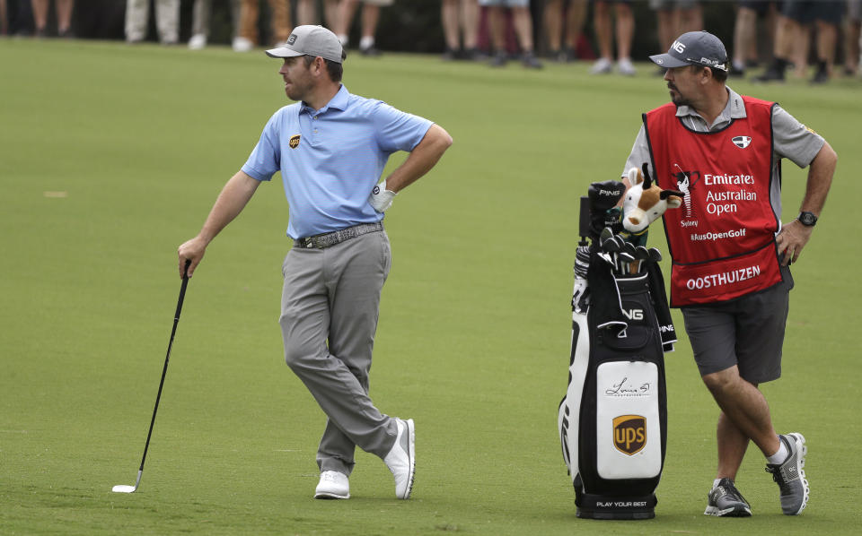 South Africa's Louis Oosthuizen, left, waits to play his second shot on the 6th hole during the second round of the Australian Open golf tournament in Sydney, Friday, Dec. 6, 2019. (AP Photo/Rick Rycroft)