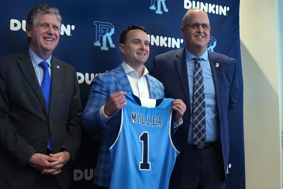 Rhode Island Gov. Dan McKee and URI director of athletics Thorr Bjorn flank the college's new men's basketball head coach Archie Miller at the school's Welcome Center on March 21.