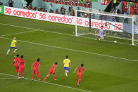 Brazil's Neymar, left, scores on a penalty kick against South Korea's goalkeeper Kim Seung-gyu, right, during the World Cup round of 16 soccer match between Brazil and South Korea, at the Education City Stadium in Al Rayyan, Qatar, Monday, Dec. 5, 2022. (AP Photo/Ariel Schalit)