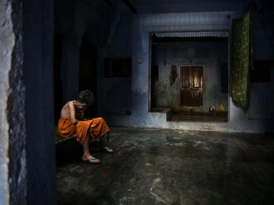 An elderly Hindu woman sits in solitude inside an ashram meant for those who come to die in Varanasi, in 2019.