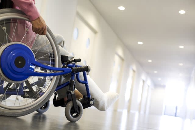 Man with broken leg in a wheelchair