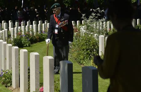 British D-Day veteran, Leonard Bloomfield, aged 93, who served in the British Navy, views gravestones at a British-French commemoration ceremony at the Commonwealth War Graves Cemetery in Bayeux, Normandy June 6, 2014. REUTERS/Toby Melville