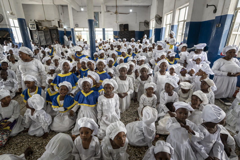 Nigerian children attend a special church service, while their parents attend another in a building nearby, at the Celestial Church of Christ in the Makoko area of Lagos, Nigeria Sunday, Feb. 26, 2023. People were still voting across Nigeria Sunday morning, the day after Africa's most populous nation was supposed to have completed elections, as logistical and security challenges caused widespread delays. (AP Photo/Ben Curtis)