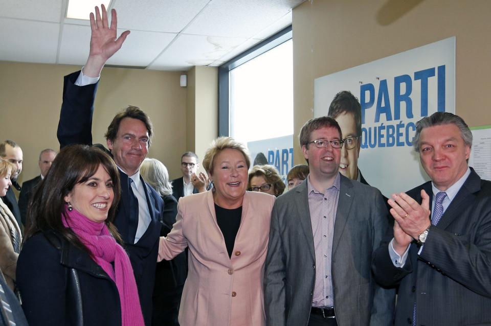 Parti Quebecois leader Pauline Marois smiles as she arrives at an electoral office with candidates Veronique Hivon, Pierre-Karl Peladeau and Clement Laberge during a campaign stop in Quebec City