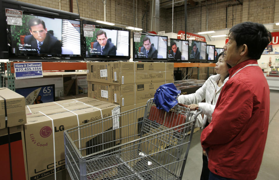 FILE - In this Feb. 22, 2009, file photo shoppers watch the television show "The Office" as they compare wide screens on display at Costco in Mountain View, Calif. Netflix's announced that NBC's hit show "The Office" will be pulled from its lineup after 2020 and head to NBCUniversal's upcoming service. In a tweet Tuesday, June 25, Netflix said it was "sad" that NBC was taking back the show but added it will still be on Netflix for the next year and a half. (AP Photo/Paul Sakuma, File)