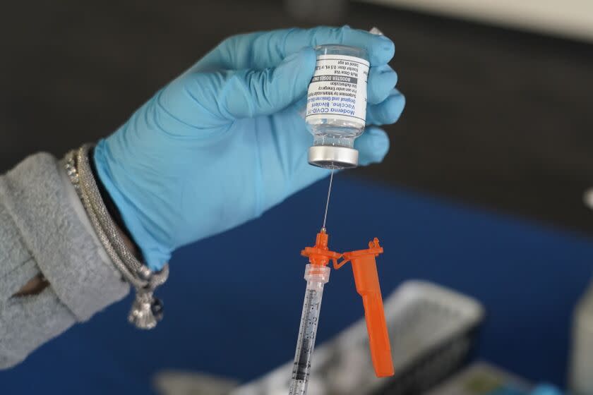 A Jackson-Hinds Comprehensive Health Center nurse loads a syringe with a Moderna COVID-19 booster vaccine at an inoculation station next to Jackson State University in Jackson, Miss., Friday, Nov. 18, 2022. Moderna recently announced early evidence that its updated booster induced BQ.1.1-neutralizing antibodies. (AP Photo/Rogelio V. Solis)