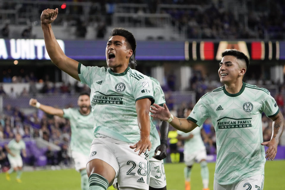 Atlanta United forward Tyler Wolff (28) celebrates after his goal against Orlando City with teammates including midfielder Thiago Almada, right, during the second half of an MLS soccer match, Saturday, May 27, 2023, in Orlando, Fla. (AP Photo/John Raoux)