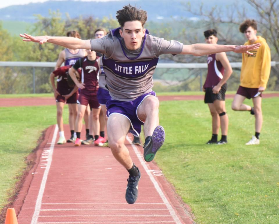 Little Falls Mountie Gavin Dibble competes in the long jump Monday during a dual meet against Frankfort-Schuyler. Dibble won that event along with both hurdling contests.