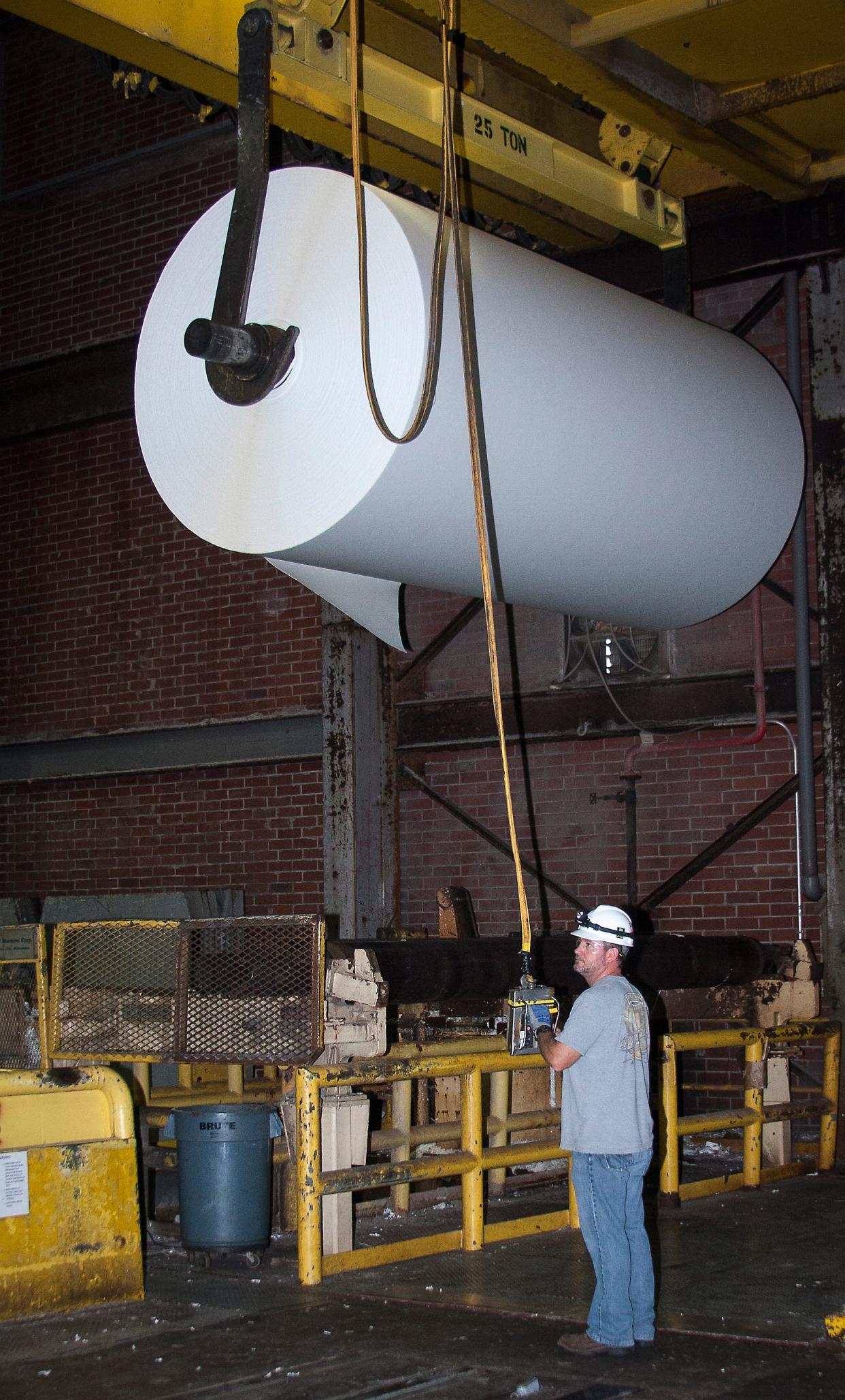 A worker uses a crane to lift a roll of cellulose fiber product at the Foley plant in this 2012. Each roll can weigh up to 15 tons. Buckeye Technologies Inc. initiated a series of projects to reduce its reliance on fossil fuels. The Foley Cellulose mill in Perry, Florida, announced on Sept. 18, 2023, that Georgia-Pacific plans to permanently close the plant.