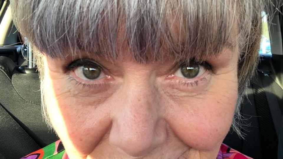 Dawn French showing off grey fringe and colourful top