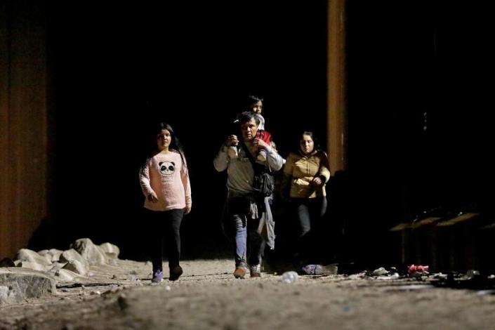 SOMERTON, AZ - MAY 11: Immigrants turn themselves over to U.S Border Patrol agents along the U.S.-Mexico border on Thursday, May 11, 2023 in Somerton, AZ. Title 42, a pandemic-era policy that allowed border agents to quickly turn back migrants, expires this week. Under a new rule, the U.S. on Thursday will begin denying asylum to migrants who show up at the U.S.-Mexico border without first applying online or seeking protection in a country they passed through. (Gary Coronado / Los Angeles Times)