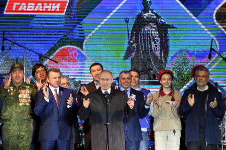 Russian President Vladimir Putin addresses the crowd during a concert marking the fifth anniversary of Russia's annexation of Crimea, in Simferopol March 18, 2019. Yuri Kadobnov/Pool via REUTERS
