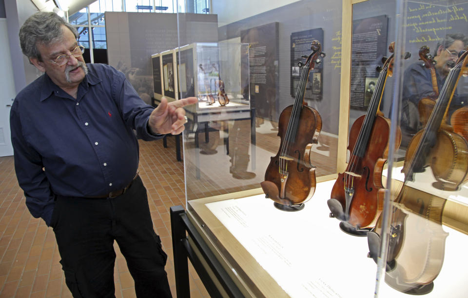 In a Monday, April 9, 2012 photo, Violin maker Amnon Weinstein talks about the stories behind the Violins of Hope exhibit at UNC Charlotte in Charlotte, N.C., Monday, April 9, 2012. Eighteen violins recovered from the Holocaust and restored by Weinsten make their U.S. debut on Sunday, April 15. Some were played by Jewish prisoners in Nazi concentration camps, while others belonged to the Jewish Klezmer musical culture. (AP Photo/Chuck Burton)