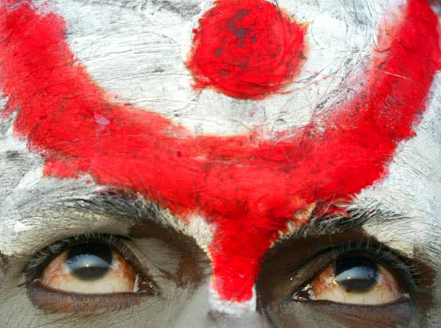 A Sadhu, or Hindu holy man, looks on during the annual cattle fair in Pushkar, in the northern Indian state of Rajasthan, some 415 kilometers (257 miles) northwest of the capital New Delhi, Friday, Nov. 3, 2006. Pushkar, located on the banks of Pushkar Lake, is a popular Hindu pilgrimage spot that is also frequented by foreign tourists who come to the town for the annual cattle fair and camel races. (AP Photo/Rajesh Kumar Singh)