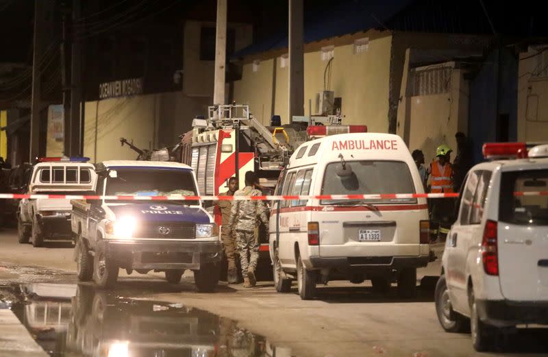 Emergency vehicles are seen at a cordoned off area near the site of a blast at the Elite Hotel in Lido beach in Mogadishu