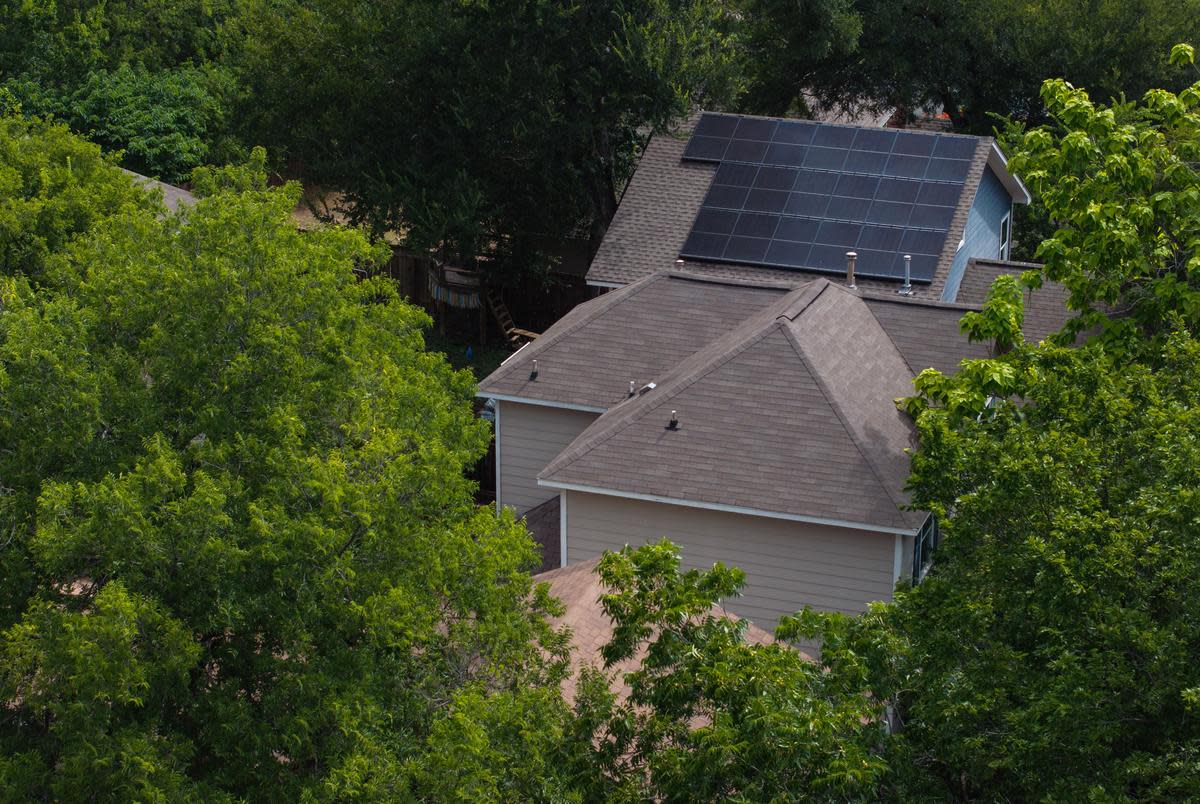 Solar panels can be seen on the roofs of homes Sunday, July 7, 2024 in East Austin.