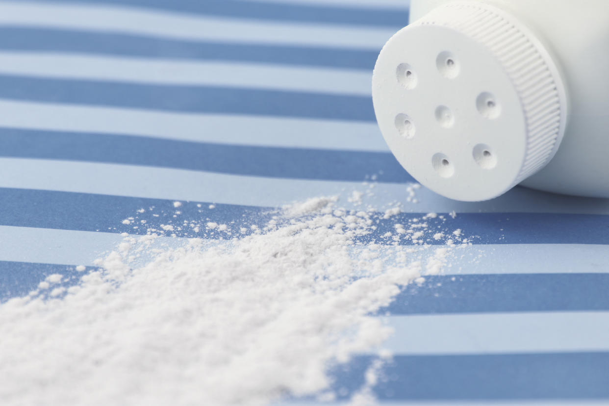 Spilled baby scented powder on striped background with short depth of field