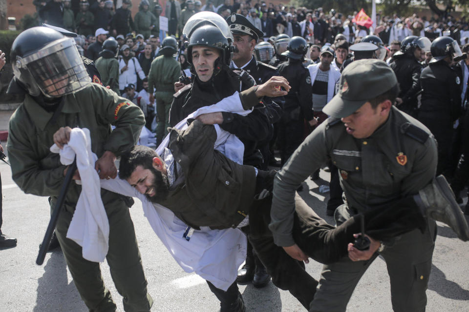 Security forces detain a protesting teacher during a demonstration in Rabat, Morocco, Wednesday, Feb. 20, 2019. Moroccan police fired water cannons at protesting teachers who were marching toward a royal palace and beat people with truncheons amid demonstrations around the capital Wednesday. (AP Photo/Mosa'ab Elshamy)