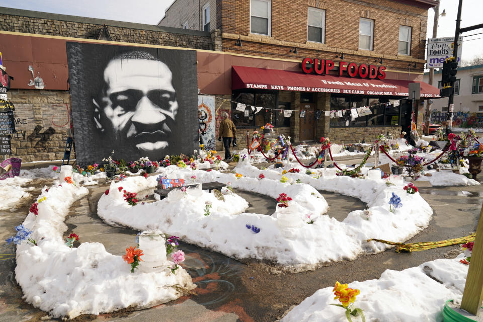 FILE - In this Feb. 8, 2021 file photo, A mural of George Floyd is seen in George Floyd Square in Minneapolis. The city of Minneapolis on Friday, March, 12, 2021, agreed to pay $27 million to settle a civil lawsuit from George Floyd's family over the Black man's death in police custody, as jury selection continued in a former officer's murder trial. The settlement includes $500,000 for the south Minneapolis neighborhood that includes the 38th and Chicago intersection that has been blocked by barricades since his death, with a massive metal sculpture and murals in his honor. (AP Photo/Jim Mone File)