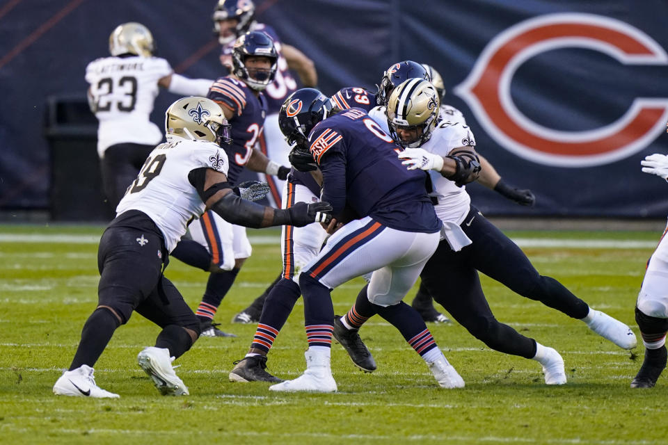 Chicago Bears quarterback Nick Foles (9) is sacked by New Orleans Saints defensive tackle Sheldon Rankins (98) and defensive end Brent Urban (92) in the first half of an NFL football game in Chicago, Sunday, Nov. 1, 2020. (AP Photo/Nam Y. Huh)