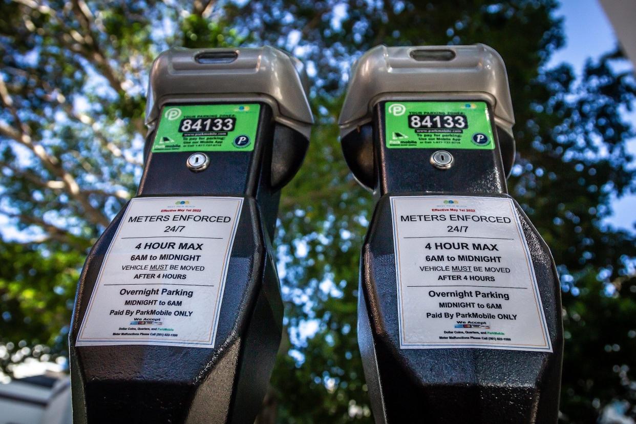 Sticker signage on downtown West Palm Beach parking meters notify motorists of the new enforcement schedule.