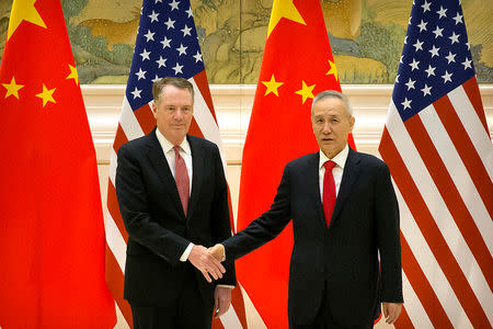 U.S. Trade Representative Robert Lighthizer, left, and Chinese Vice Premier and lead trade negotiator Liu He shake hands as they pose for a photo before the opening session of trade negotiations at the Diaoyutai State Guesthouse in Beijing, Thursday, Feb. 14, 2019. Mark Schiefelbein/Pool via REUTERS