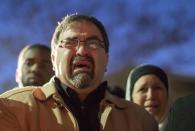 Namee Barakat, father of shooting victim Deah Shaddy Barakat, cries as a video is played during a vigil on the campus of the University of North Carolina in Chapel Hill, North Carolina February 11, 2015. Gunman Stephen Hicks, who had posted anti-religious messages on Facebook and quarreled with neighbors, was charged with killing three young Muslims in what police said on Wednesday was a dispute over parking and possibly a hate crime. The victims were newlyweds Deah Shaddy Barakat, 23, a University of North Carolina dental student, and his wife Yusor Mohammad, 21, and Yusor's sister, Razan Mohammad Abu-Salha, 19. (REUTERS/Chris Keane)