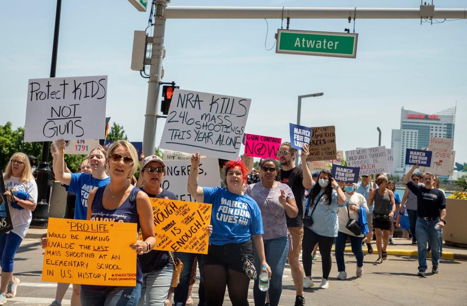 Marchers hold signs and chant as they leave the Detroit Cities Riverfront on Saturday, June 11, 2022, as they march in the March for Our Lives Detroit event. Speakers came to the microphone one by one and demanded that lawmakers enact gun control laws to keep these tragedies from happening again.